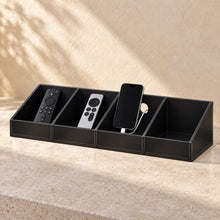 Bedside Remote and Phone Caddy in black acrylic, in use