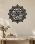 Panjtan Pak round acrylic medallion in gloss piano black, float-mounted on an ivory wall
