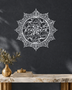Panjtan Pak round acrylic medallion in mirror silver, float-mounted on a cool graphite wall