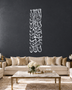 Mirror silver chrome Kalima calligraphy, Thuluth lines stacked in a tall vertical column, float-mounted clear of a stone-grey wall