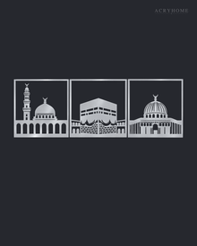 Three mirror silver acrylic panels showing the three holy mosques in architectural silhouette, arranged as a set on a light neutral wall.