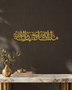 Mashallah Tabarakallah calligraphy in mirror gold acrylic, cut as one flowing line of Thuluth and mounted above a console table.