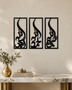 Set of three narrow vertical acrylic wall panels in gloss piano black, each framing a single Arabic word in tall flowing calligraphy, float-mounted in a row on a pale wall.