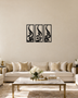 Set of three narrow vertical acrylic wall panels in gloss piano black, each framing a single Arabic word in tall flowing calligraphy, float-mounted in a row on a pale wall.