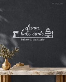 Bakery & Patisserie Wall Sign with Mixer and Cake in mirror silver acrylic, float-mounted on a deep graphite wall.