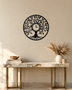 Tree of Life wall clock in gloss piano black acrylic, laser-cut leaf and branch work inside a circle, with the clock hands set into the centre of the trunk.