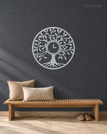 Tree of Life wall clock in mirror silver acrylic, circular leaf and branch cut work with the clock hands at the centre of the trunk.