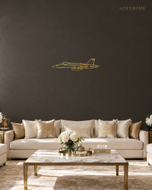 Fighter Jet Outline Wall Art for Pilots and Aviation Fans in mirror gold acrylic, float-mounted on a deep charcoal wall.