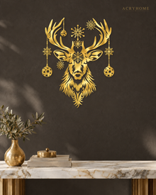 Stag Head Christmas Wall Art with Hanging Baubles and Snowflakes in mirror gold acrylic, float-mounted on a deep charcoal wall.