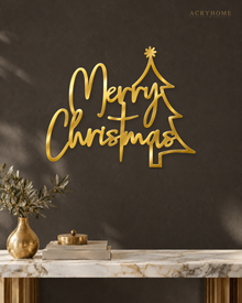 Merry Christmas Script Wall Sign with Outline Tree in mirror gold acrylic, float-mounted on a deep charcoal wall.