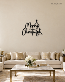 Merry Christmas Script Wall Sign with Outline Tree in gloss piano black acrylic, float-mounted on a pale ivory wall.