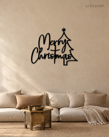Merry Christmas Script Wall Sign with Outline Tree in gloss piano black acrylic, float-mounted on a pale ivory wall.