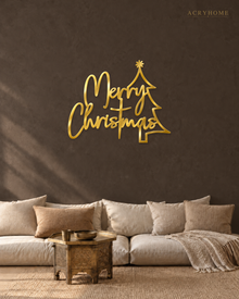 Merry Christmas Script Wall Sign with Outline Tree in mirror gold acrylic, float-mounted on a deep charcoal wall.