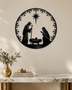 Round Nativity scene wall art in gloss piano black acrylic — Mary, Joseph and the manger beneath the star, ringed by a pine and snowflake wreath, float-mounted on a pale wall.