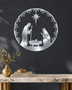 Round Nativity scene wall art in mirror chrome silver acrylic — Mary, Joseph and the manger beneath the star, ringed by a pine and snowflake wreath, float-mounted on a pale wall.