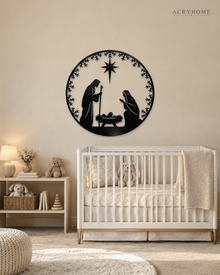 Round Nativity scene wall art in gloss piano black acrylic — Mary, Joseph and the manger beneath the star, ringed by a pine and snowflake wreath, float-mounted on a pale wall.