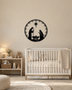 Round Nativity scene wall art in gloss piano black acrylic — Mary, Joseph and the manger beneath the star, ringed by a pine and snowflake wreath, float-mounted on a pale wall.