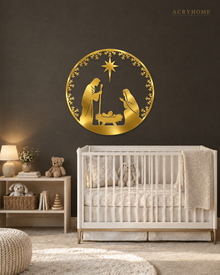 Round Nativity scene wall art in mirror gold acrylic — Mary, Joseph and the manger beneath the star, ringed by a pine and snowflake wreath, float-mounted on a pale wall.