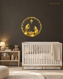 Round Nativity scene wall art in mirror gold acrylic — Mary, Joseph and the manger beneath the star, ringed by a pine and snowflake wreath, float-mounted on a pale wall.