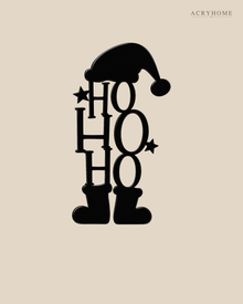Ho Ho Ho Christmas Wall Art with Hat and Boots in gloss piano black acrylic, float-mounted on a pale ivory wall.
