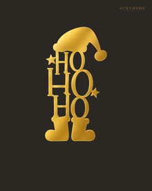 Ho Ho Ho Christmas Wall Art with Hat and Boots in mirror gold acrylic, float-mounted on a deep charcoal wall.