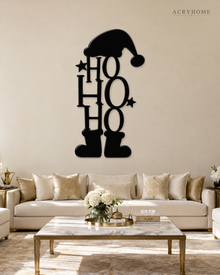 Ho Ho Ho Christmas Wall Art with Hat and Boots in gloss piano black acrylic, float-mounted on a pale ivory wall.