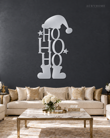 Ho Ho Ho Christmas Wall Art with Hat and Boots in mirror silver acrylic, float-mounted on a deep graphite wall.