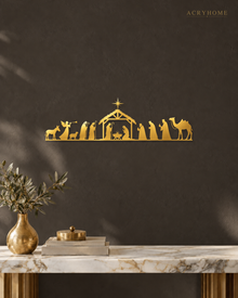 Wide Nativity Procession Wall Art with Camel and Angel in mirror gold acrylic, float-mounted on a deep charcoal wall.