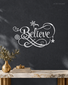 Believe in ornate flowing script with snowflake and flourish detail, laser-cut from mirror silver acrylic and float-mounted over a mantel.