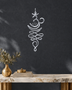 Unalome and lotus line wall art in mirror silver chrome acrylic, reflecting soft daylight on a pale wall.