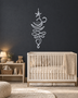 Unalome and lotus line wall art in mirror silver chrome acrylic, reflecting soft daylight on a pale wall.