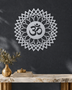 Mirror chrome acrylic Om sunburst mandala wall art, float-mounted so the layered petal rings cast a soft shadow on the wall