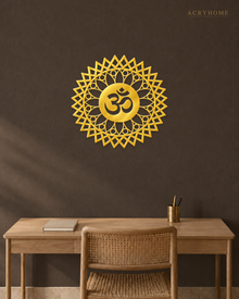 Mirror gold acrylic Om mandala wall art with geometric sunburst rings, float-mounted and catching warm light on a neutral wall