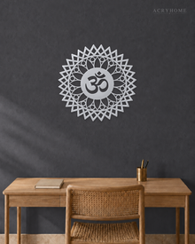 Mirror silver acrylic Om sunburst mandala wall art, float-mounted so the layered petal rings cast a soft shadow on the wall