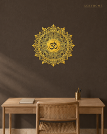 Om lotus mandala acrylic wall art in mirror gold, float-mounted on a dark espresso wall