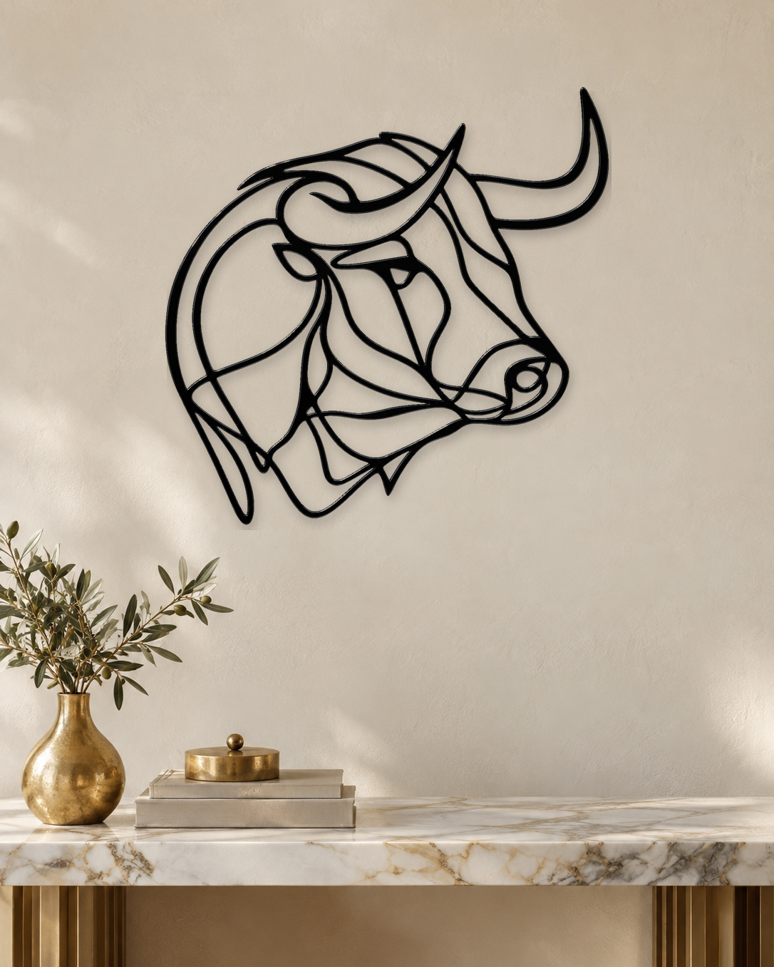 Bull's head drawn as one continuous line, laser-cut in gloss piano black acrylic and float-mounted on a pale wall.