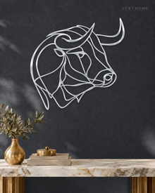 Mirror silver acrylic bull line-art wall piece standing off a neutral wall.
