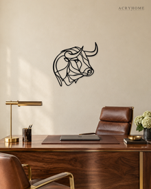 Bull's head drawn as one continuous line, laser-cut in gloss piano black acrylic and float-mounted on a pale wall.