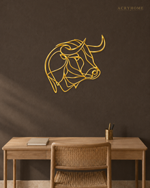 Mirror gold acrylic bull's head in a single continuous line, float-mounted above a console table.