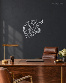 Mirror silver acrylic bull line-art wall piece standing off a neutral wall.