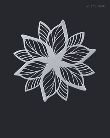 Layered Bloom flower wall art in mirror silver acrylic, geometric petals radiating from a central point on a pale wall.