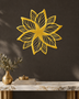 Layered Bloom flower wall art in mirror gold acrylic, layered petals catching light above a living room wall.