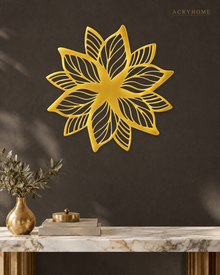 Layered Bloom flower wall art in mirror gold acrylic, layered petals catching light above a living room wall.