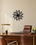 Layered Bloom flower wall art in gloss piano black acrylic, overlapping pointed petals float-mounted on a plain wall.