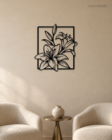 Lily line art wall piece in gloss piano black acrylic, stems and long leaves crossing a thin rectangular frame, float-mounted on a pale wall.