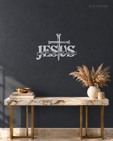 JESUS wall art in mirror silver acrylic, heavy block letters with a cross and nails set into the lettering and a banner beneath reading The Way, The Truth, The Life, float-mounted on a pale wall