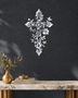 Floral filigree cross wall art in mirror silver chrome acrylic against a neutral wall