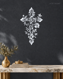 Floral filigree cross wall art in mirror silver acrylic against a neutral wall