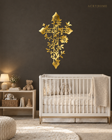 Floral filigree cross wall art in mirror gold acrylic, vines and blossoms catching warm light