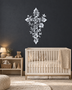 Floral filigree cross wall art in mirror silver chrome acrylic against a neutral wall